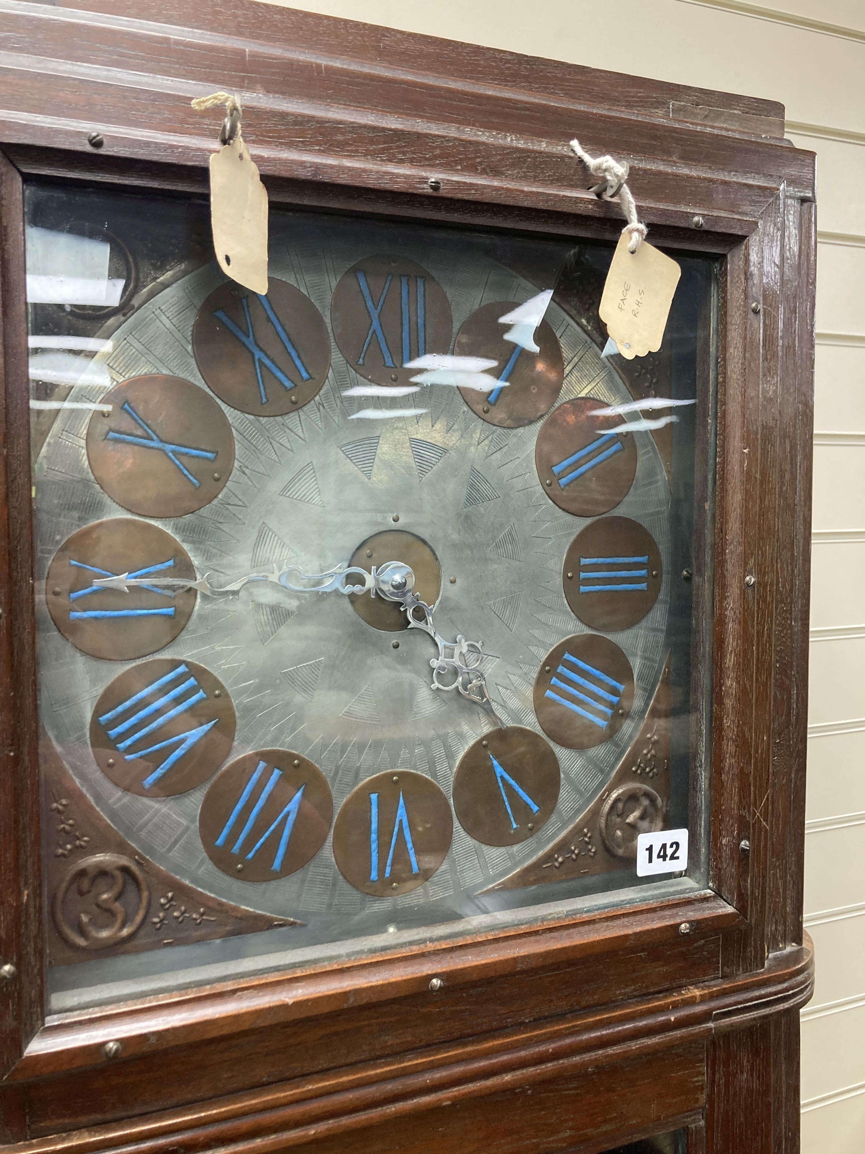A large and unusual 20th century oak cased longcase clock, in the arts and crafts style, after Mackintosh, the 13 engraved dial with c